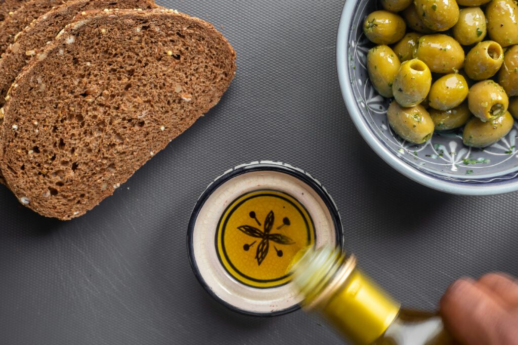 Knowing Extra Virgin Olive Oil for Cooking And Proven Benefits and Pitfalls showing extra virgin olive oil being used in a fresh and nutritious meal preparation.